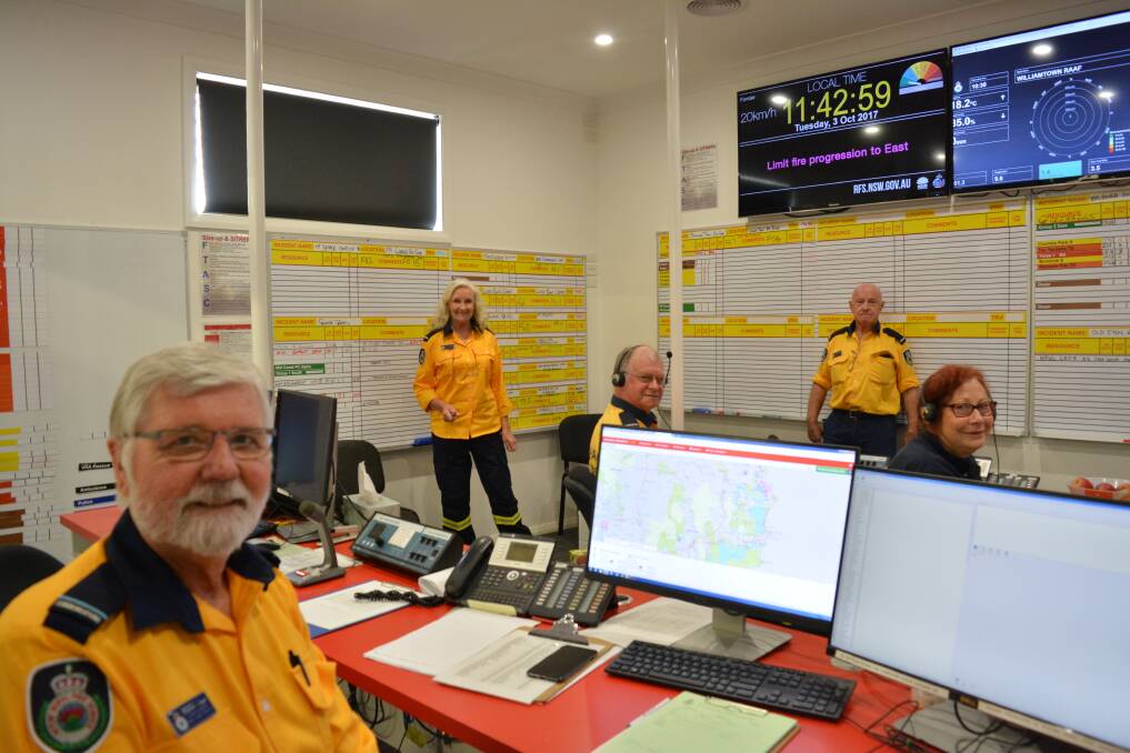 Communication cell: Stephen Logan Robyn O'Meara, Ian Bartholomew, Jacqui Keats and Colin McCarthy at the NSW RFS Mid Coast Incident Management Centre in Tuncurry during the 2017 bush fire season. Photo: Anne Keen 