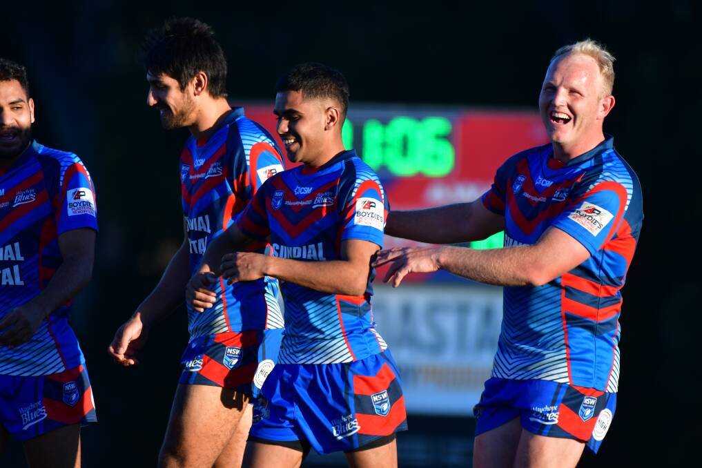Improving: Wauchope hooker Tyrell Scott is congratulated after his first-half try. Photo: Paul Jobber