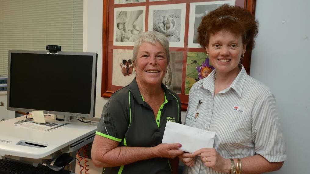 Wendy Murray of Nabiac Hay and Rural hands Manning Hospital's Tracey Laidlaw a cheque for over $1500 to go towards the children's ward. 
