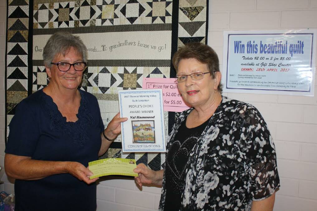 Val Hammond, maker of the winning quilt, receiving her award from Pam Eyb of Taree Craft Centre. 