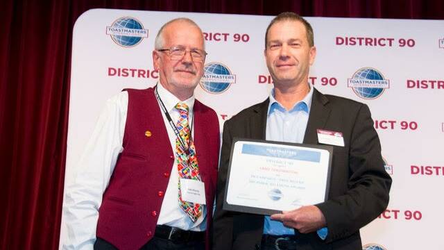Director of Toastmasters’ Area 5 Colin Steber after receiving the award from District 90 public relations manager Udo Moering.