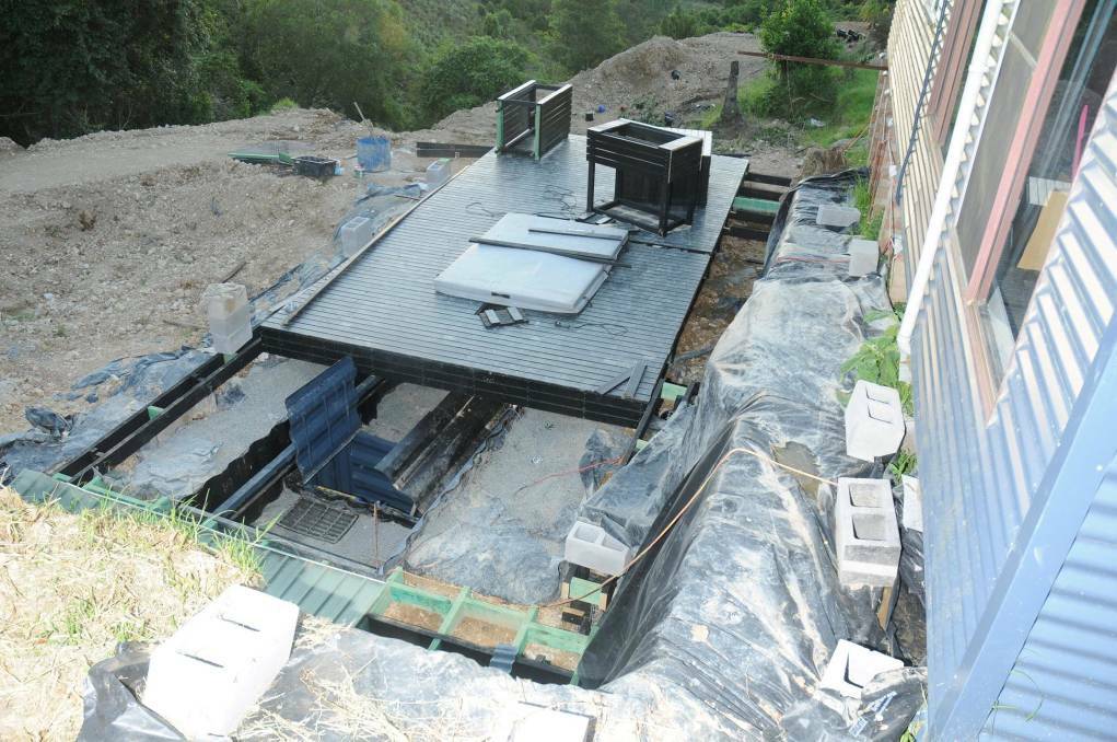The deck at the Elands property which has partially moved away to show a trapdoor, which led to three buried shipping containers where a large hydroponic cannabis set up was discovered.