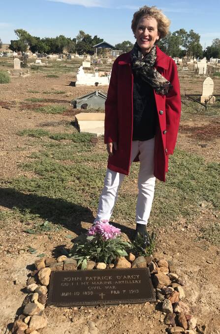 Dianne Hensler with her great great uncle's grave after the addition of the plaque earlier this year. 