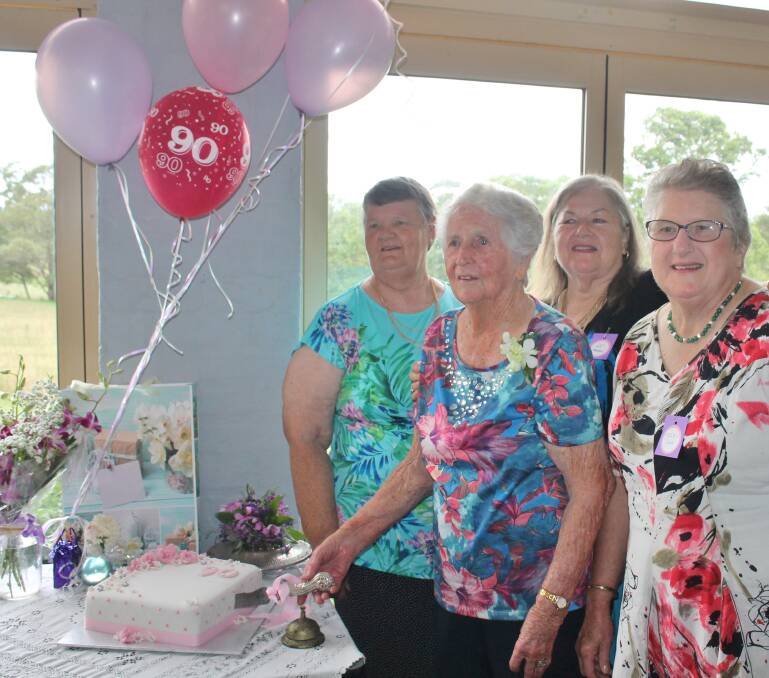 Gwen Greaves with nieces Pam Muxlow, Di Greaves-Hayne and Helen Cox cutting her 90th birthday cake.