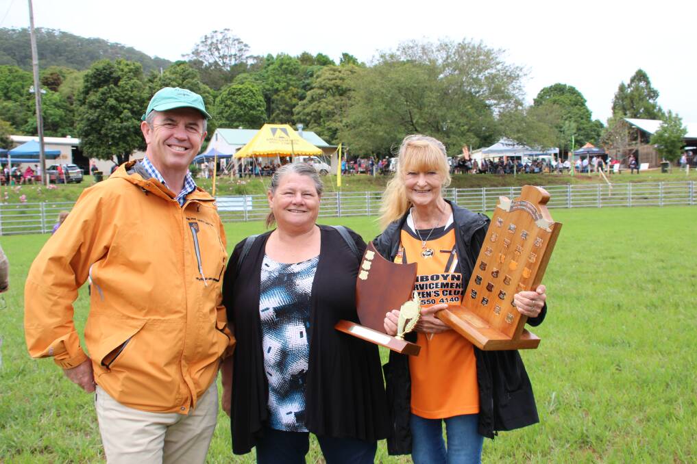 Still smiling: Despite the rain making it wet under foot, the Comboyne Show was just what the locals needed to boost their spirits. Here Lyne MP Dr David Gillespie congratulates Joy Hurrell and Kay White.