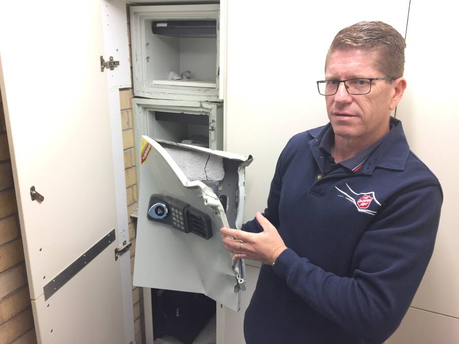 Salvation Army major Michael Hogg with one of two safe doors destroyed to gain access to money. Photo: Ainslee Dennis.