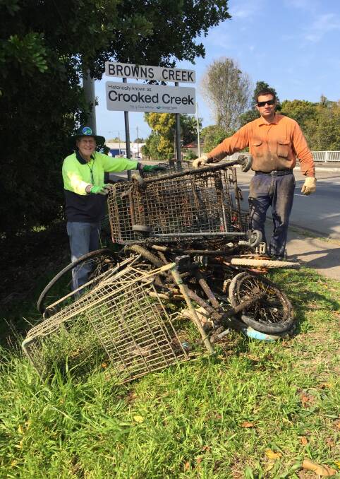 Friends of Browns Creek volunteers Bill Dennis of Taree, and Jigh Turner of Wingham, with the catch from their recent rubbish fishing expedition in Taree. The volunteers worked for hours to pull the items from Browns Creek.