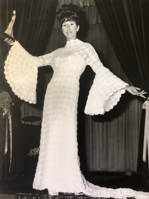 Dawn Goulder models the 1972 Gown of the Year. Around 4900 yards of nylon ribbon was used to create the 1400 crochet daises.