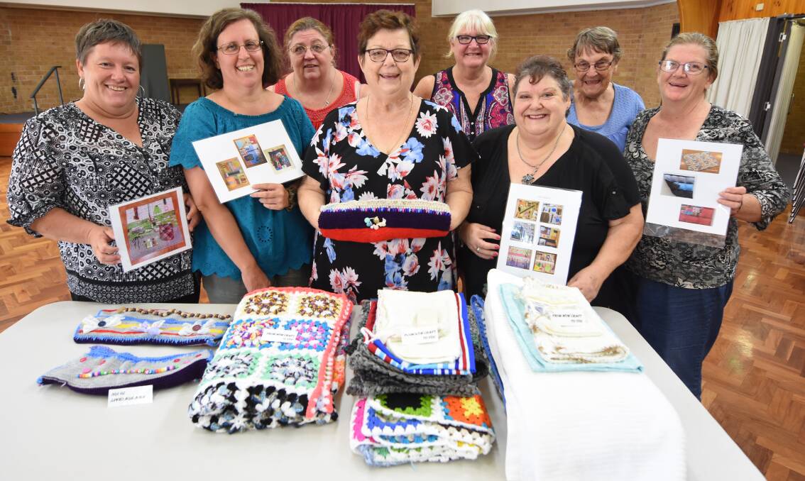 Community crafters: Laura Price, Rebecca Hogan, Donna Fowler, Kath Robinson, Christine Bennett, Narelle Gallagher, Joyce Watson and Nellie Turner with some of the weighted blankets and twiddle mitts they have made to help children and adults living with anxiety, autism and dementia. They are now working to create sleeping mats for the homeless.