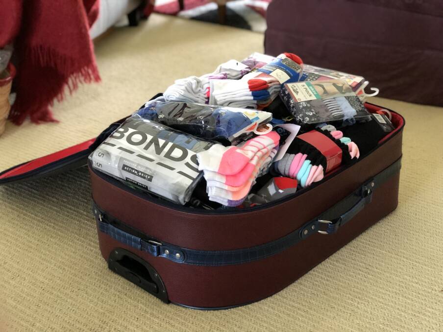 One of two suitcases packed full of donated socks and undies from people in Taree and the Great Lakes. Photo: Ainslee Dennis.