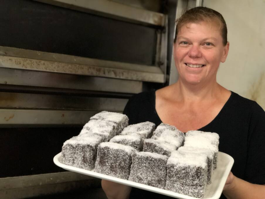 Large lamingtons fill the tray of Harrington Bakehouse owner, Ros Shelton. Plans are in the pipeline to celebrate National Lamington Day. Photo: Ainslee Dennis.