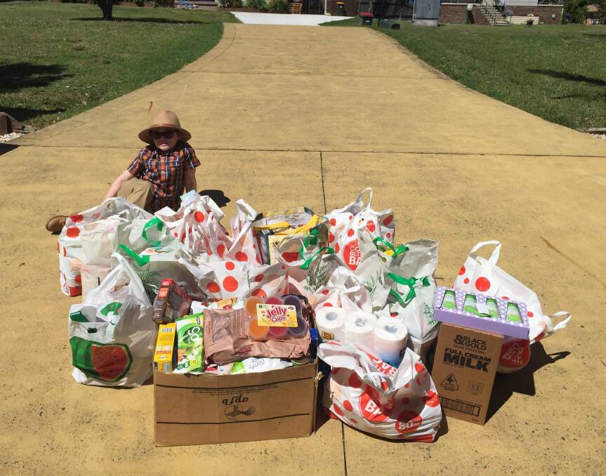 Jackson on the driveway of his Tinonee home with the boxes and bags of grocery and household items that are to be given to farmers. Photo: Amy Waldon.