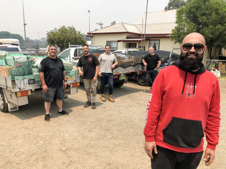Charbel Nasser (front) of Oran Park took to Facebook to organise a donation drive to help people impacted by bushfires. Friends (from left) George Wehbe, Tony Ayoub, Paul Chalhoub and Bruce Missen drove the goods to Taree Showground for distribution. Photo: Ainslee Dennis.