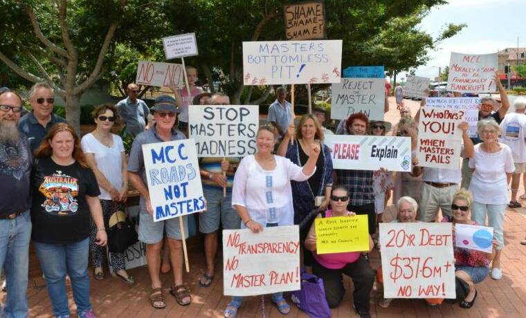 The ‘No MidCoast Council Move to Masters’ group protested at the Taree office in December. It has around 1000 members and group administrator, Katrina Stanfield yesterday called for members to attend the Forster meeting.