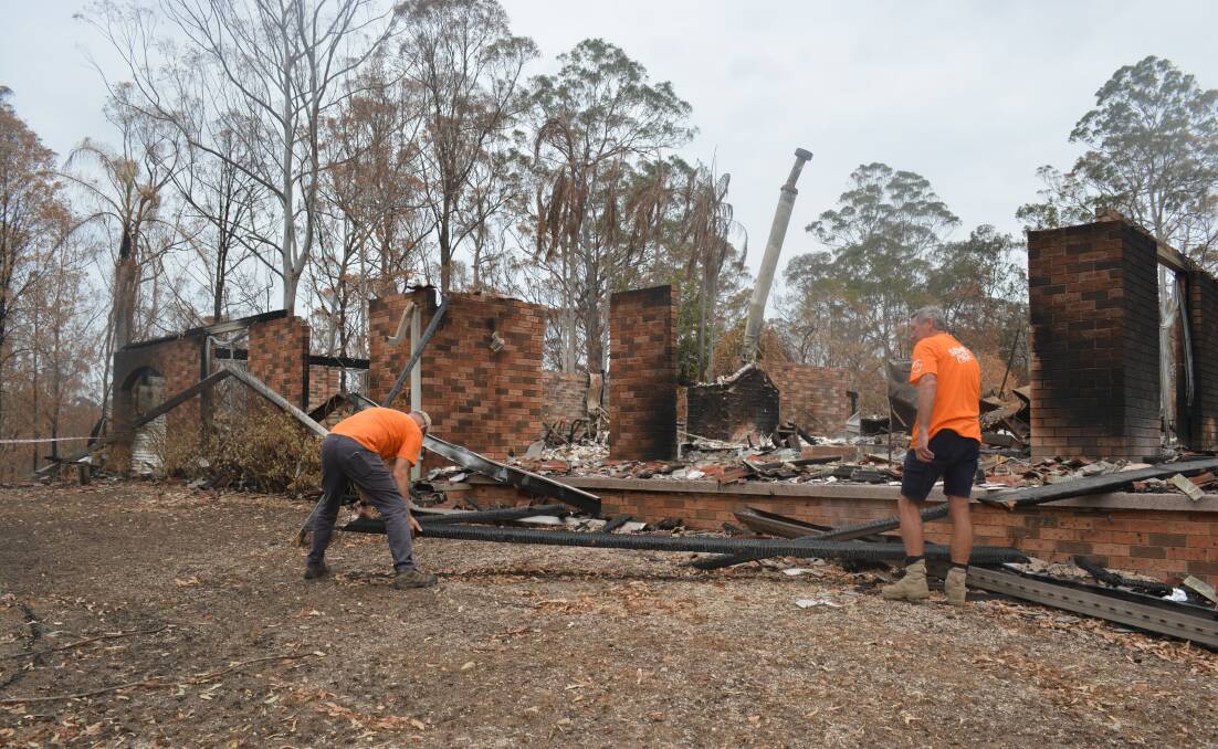 Samaritan's Purse volunteers work to help clear debris from a property destroyed by bushfire.