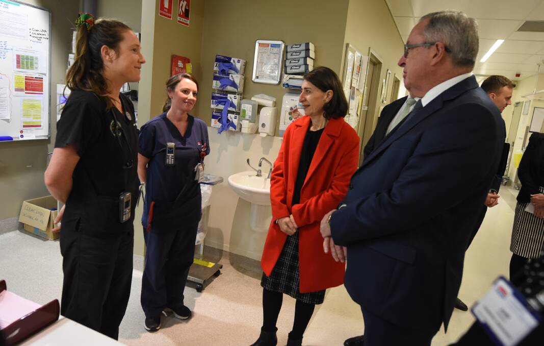NSW Premier Gladys Berejiklian and NSW health minister Brad Hazzard talk to Manning Hospital staff during a whistle-stop tour of the area in June.