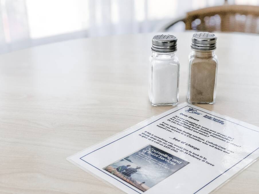 Diners at Taree Community Kitchen are invited to access CatholicCare counselling and clinical services with the placement of information flyers on tables, counselling cards on the noticeboard, and a poster on the wall. Photo: Ainslee Dennis.