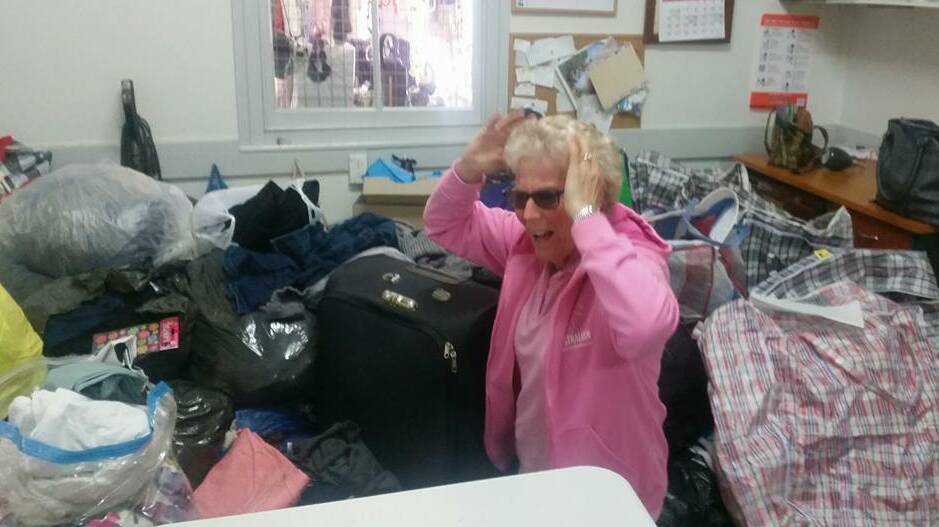 On August 20, day one of the appeal a volunteer stands among the donations. The op shop posted on its Facebook page, "It's Monday morning and the second wave of donations just hit. Our girls are drowning but going hard to get everything out on the shelves."