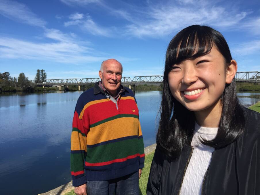 Natsuko Misawa enjoys the beauty of the Manning River at Taree on a warm winter's day with Dr Colin Rose OAM of the Rotary Club of Taree. Photo: Ainslee Dennis.
