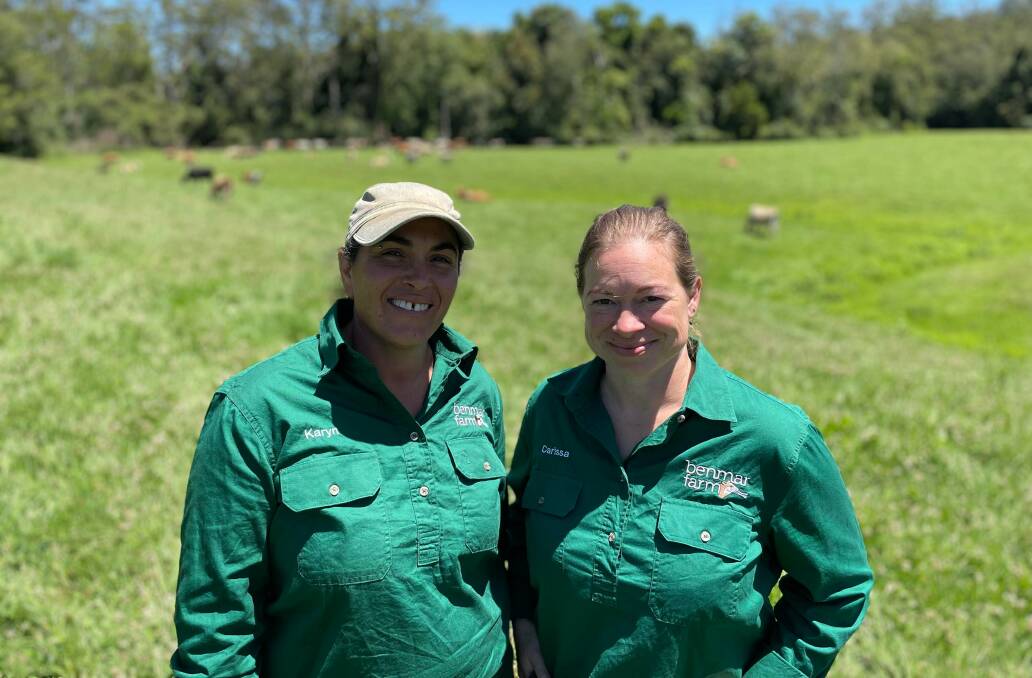Dairy farmers: Benmar Farmers Karyn Cassar and Carissa Wolfe at the Hannam Vale property with their cows in the background. 