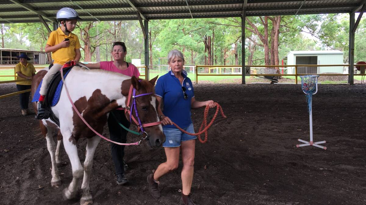 George enjoys the benefits of riding Commanche at the Riding for the Disabled Centre at Rainbow Flat.