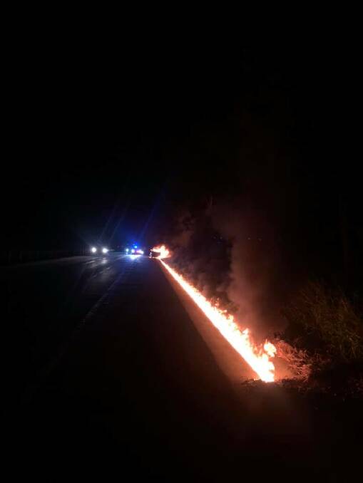 A photo shows the trail of flames the car left behind it on the Pacific Highway. Photo Traffic and Highway Patrol Command