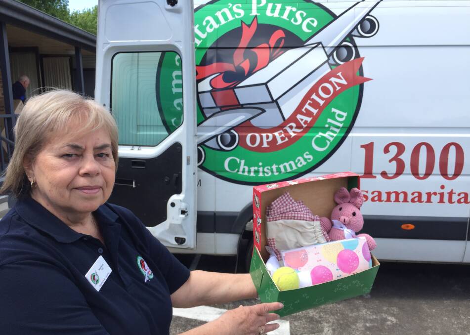 Mariann Hall shows the contents of a shoebox headed for a less fortunate child in the Pacific Rim this Christmas.