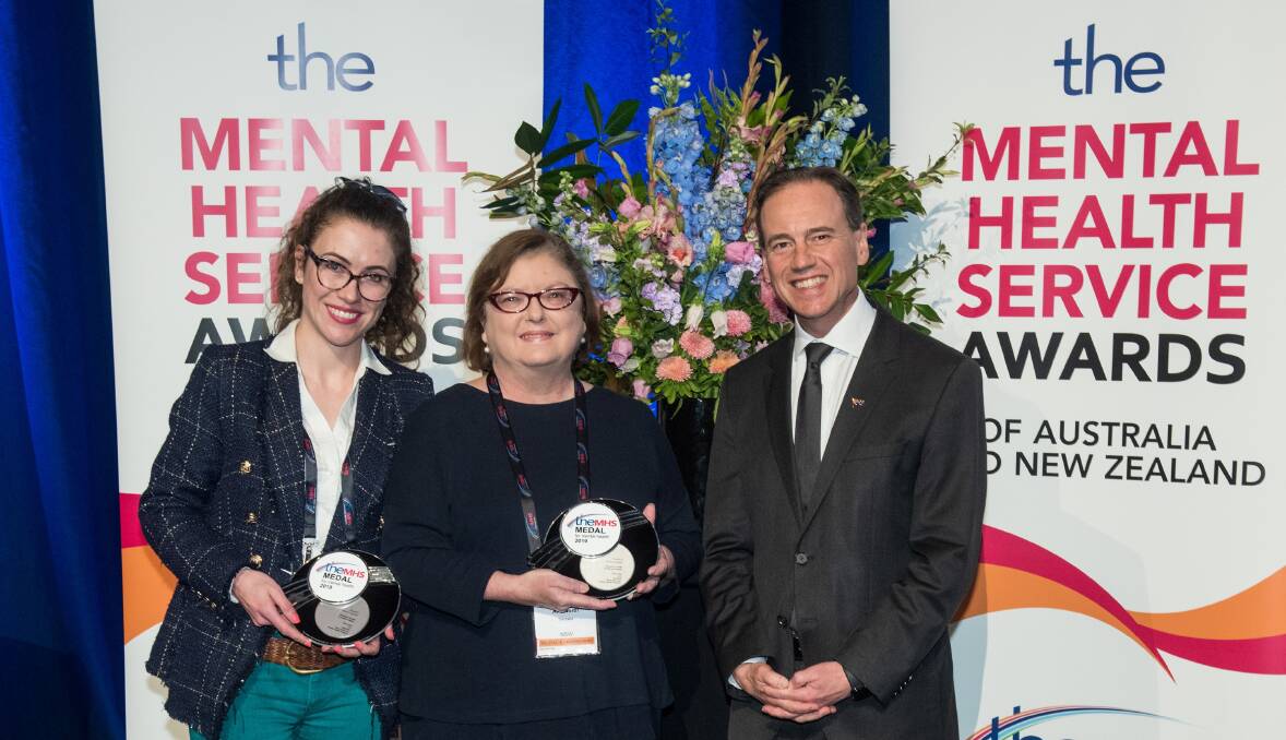 MEDAL: RAMHP program manager Tessa Caton, Robyn Ainsworth and Federal Health Minister Greg Hunt at the Mental Health Service Awards in Brisbane where the guide won TheMHS Medal.