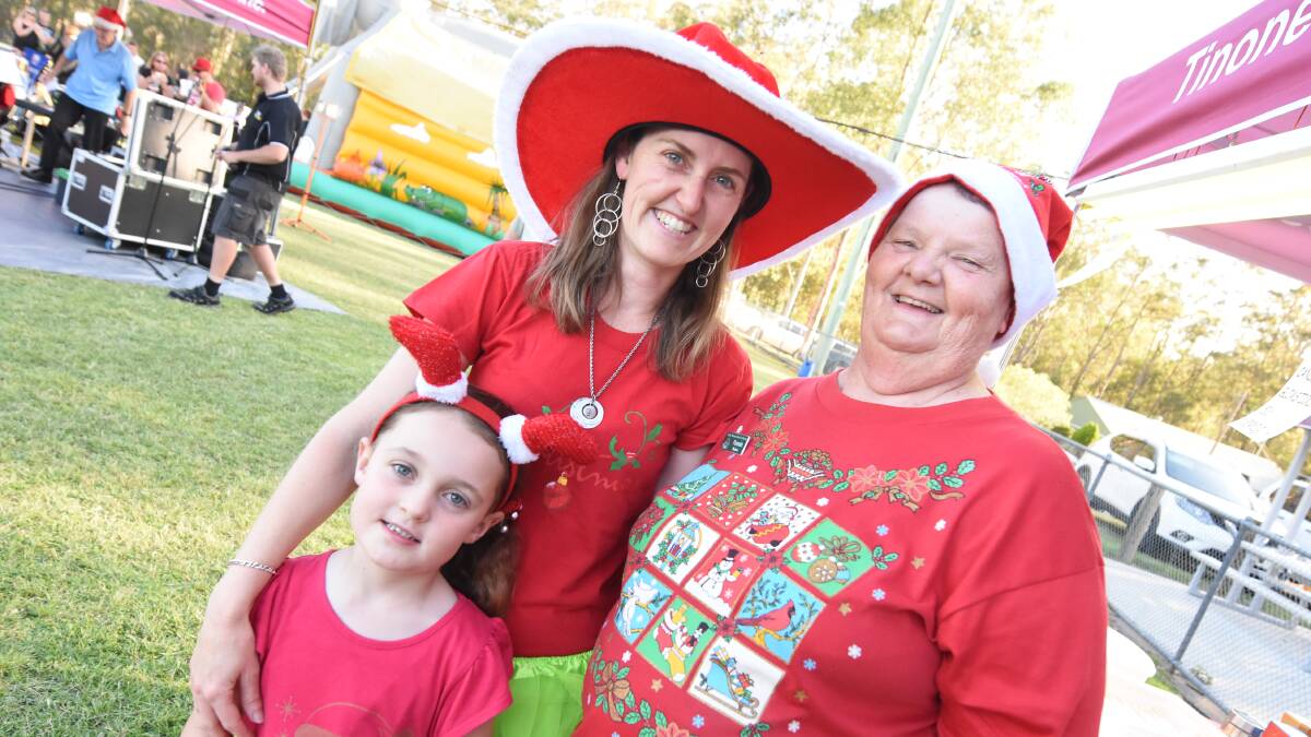 Melissa and Shelby Scott with Wingham Chronicle correspondent Pam Muxlow dressed in festive colour for the 2017 Tinonee carols. Photo: Scott Calvin
