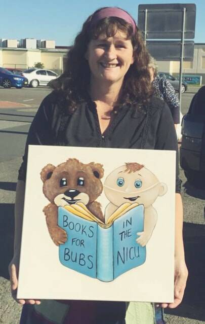 Arona with a canvas of the logo painted and donated to Books for Bubs in the NICU