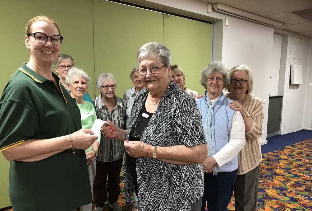 Club Taree Embroiderers president, Evelyn Young, presenting the cheque to Manning Valley Can Assist president, Janice Latimer. Photo supplied