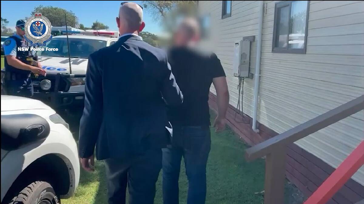 Man being arrested in Taree for international sex crimes. Picture from NSW Police video.