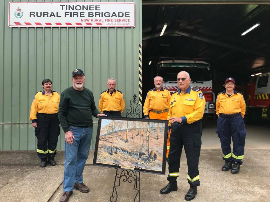 Therapuetic donation: Artist Ron Hindmarsh presenting the painting to Tinonee RFS life member Bert Bennett on behalf of the community. Photo: supplied