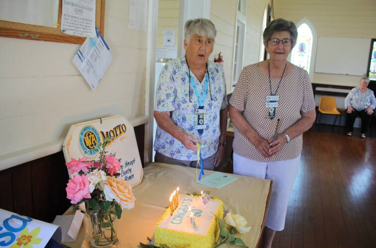 Wallamba CWA Branch president Margaret Weller the branch's mentor Topsy Roberts from Lake Cathie-Hastings Branch cut the birthday cake. Picture by Pam Muxlow. 