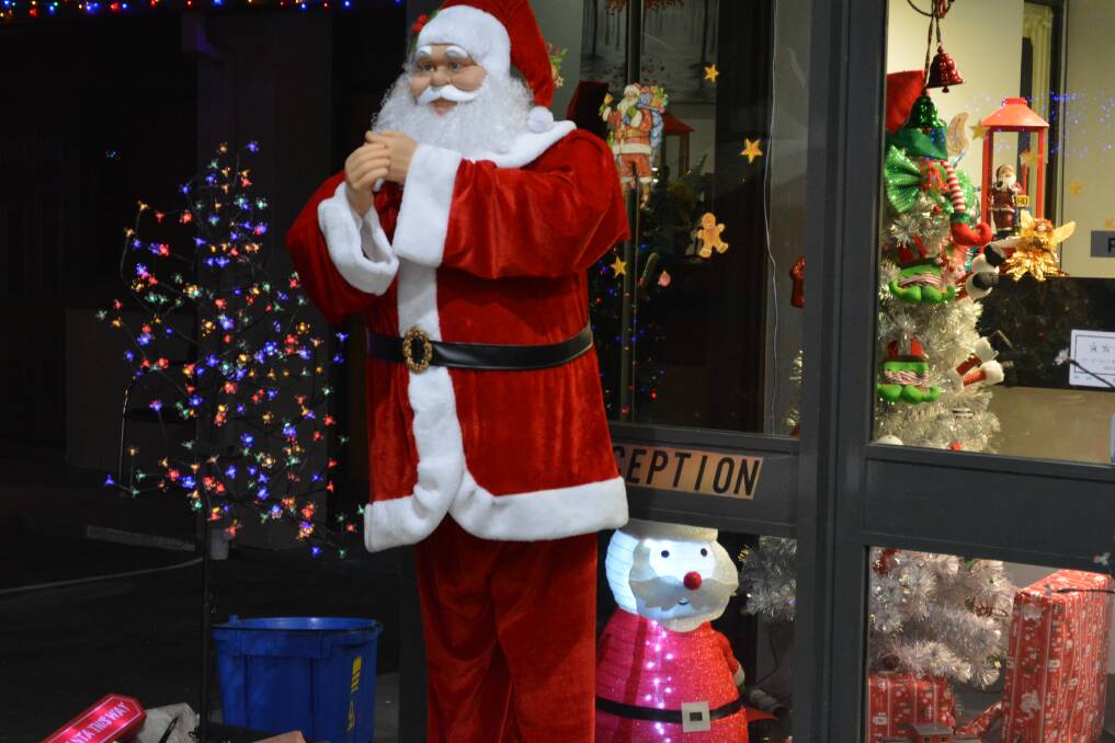 Greetings: Santa waits outside the reception door to greet the Alabaster Motor Inn's customers. Picture: supplied