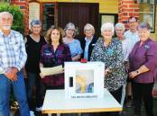 Wally Riley from Taree Masonic Lodge 44 handing over the donated defibrillator to Tinonee Memorial School of Arts Hall. Picture Pam Muxlow.