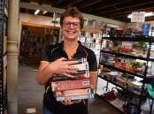 Open for business: Rotarian Sue Bell at the Rotary Book Shed at Taree Showground. Photo: Scott Calvin