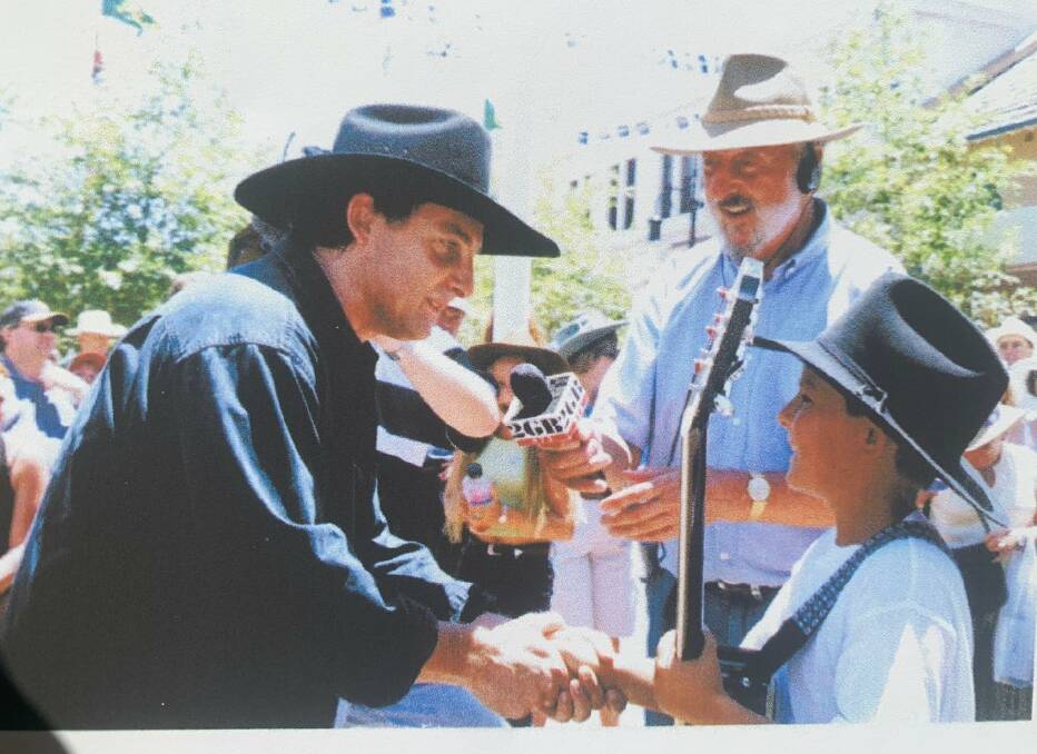 A young James Johnston meeting Lee Kernaghan at the Tamworth Country Music Festival in 2000. Photo supplied