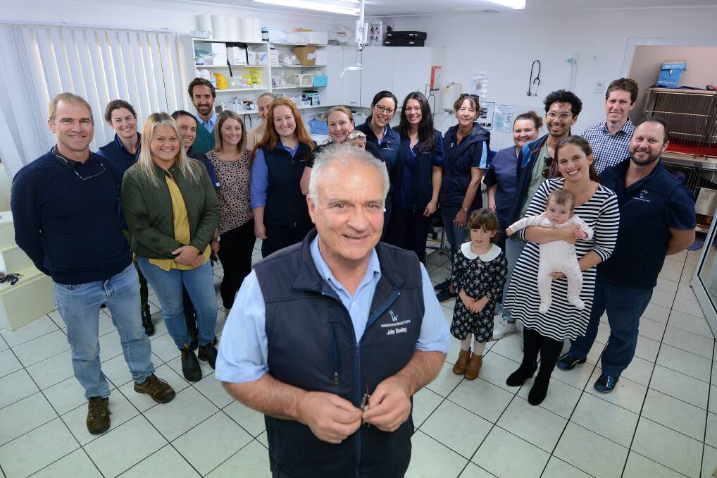 Goodbye and good luck: Dr John Dooley surrounded by workmates at Wingham and Valley Vets at his farewell lunch on his last day . Photo: Scott Calvin