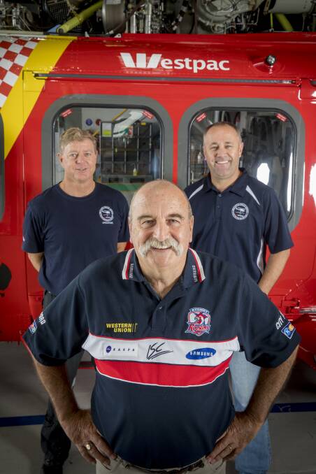Reunited: Paul Greene (centre) with his rescuers pilot Graeme Anderson and aircrewman Glen Ramplin. Photo: courtesy of Westpac Rescue Helicopter Service