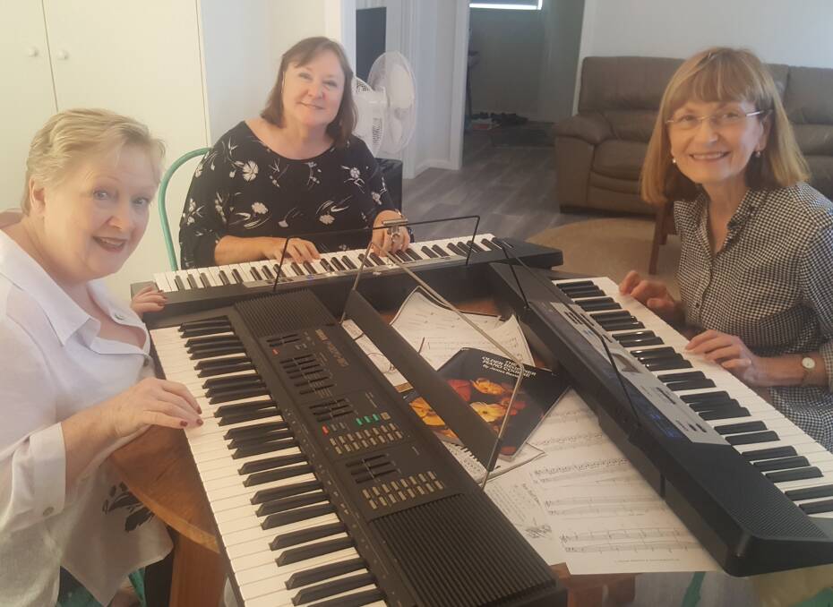 Jan, Marcia and Annette practising keyboards at the weekend workshop. Photo supplied