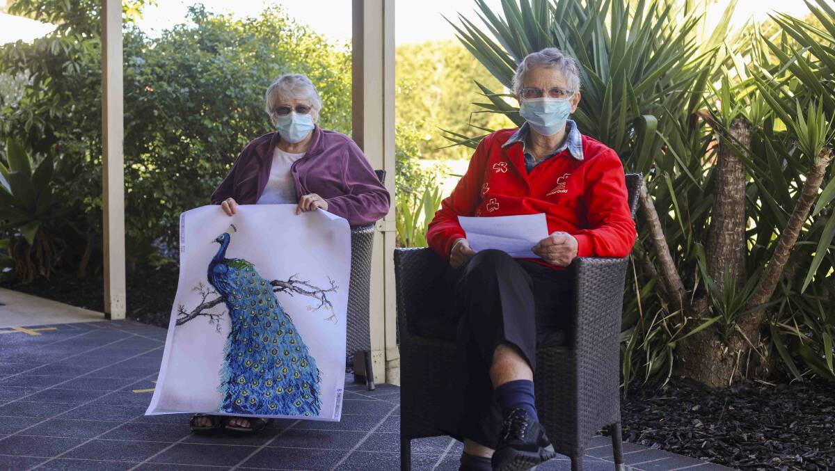 Ingenia Gardens Geelong residents Evelyn Bardenand Joy Bartlett reading a letter from Taree residents. Photo supplied