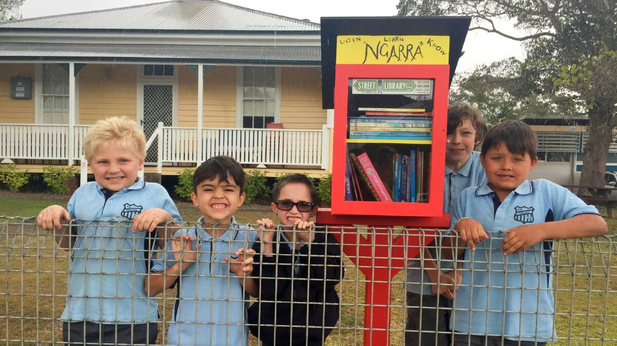 Five of Tinonee Public School's Aboriginal education students with the Street Library they helped make. Photo: Julia Driscoll
