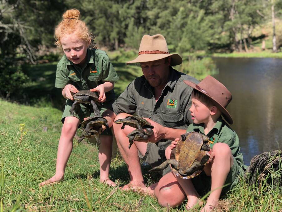 Turtle family: Tim Faulkner with sons Billy (left) and Matty with Manning River helmeted turtles they caught during a recent survey on the Manning River. Photo: courtesy Tim Faulkner
