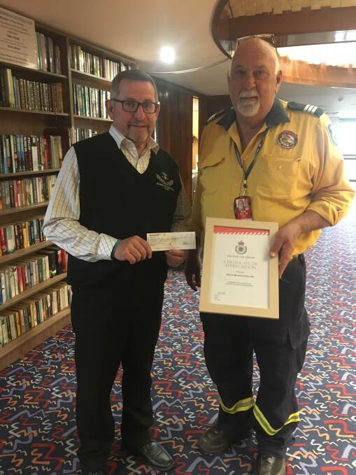 Wallaby Joe RFS captain Bob Pope receiving a donation of $999 from Wingham Memorial Services Club secretary manager Barry Murray, which will help them with the coming fire season. Photo: submitted