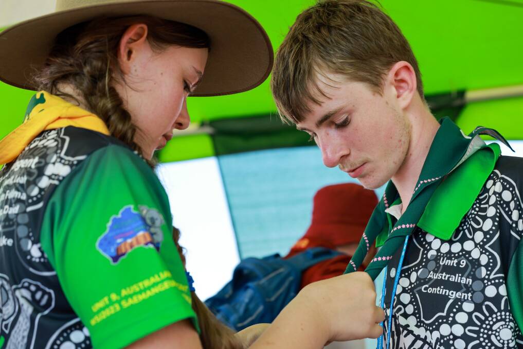 Tying friendship knots: Jake and a scout from Newcastle. Picture Scouts Australia