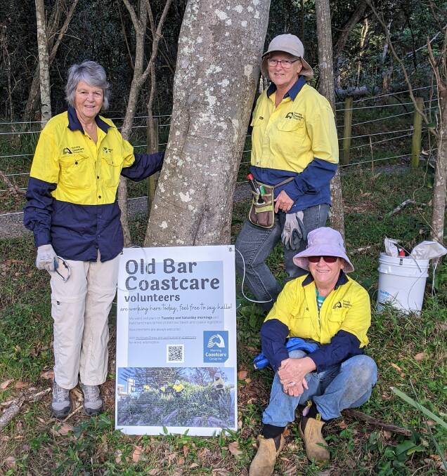 Manning Coastcare volunteers with their new worksite sign in the Old Bar littoral rainforest. Photo supplied