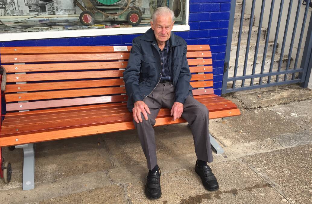 Alan's seat: The wooden seat outside Vinnies in Isabella Street, Wingham, has a plaque from Rotary dedicating the seat to Alan Carlyle. Alan is pictured here when the seat was dedicated in 2017. Photo: Julia Driscoll