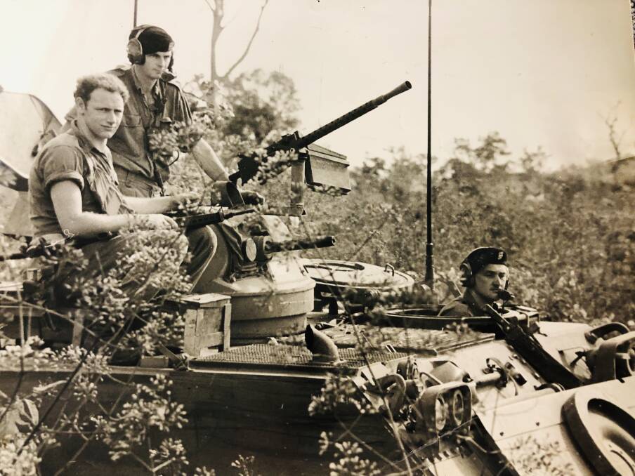 Sapper Rodney O'Regan (seated left) on an armoured personnel carrier with Cpl Merv Ellis and Trooper Len Kealey in thick jungle in Phuoc Tuy Province, South Vietnam in February 1971. They kept close guard as soldiers from A Company, 7th Battalion, Royal Australian Regiment.