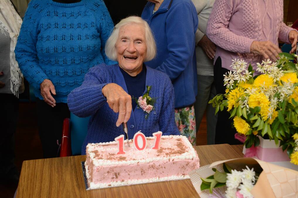 Happy birthday: Joyce Martin cutting her birthday cake at the Wingham RSL Day Club get together. Photo: Scott Calvin